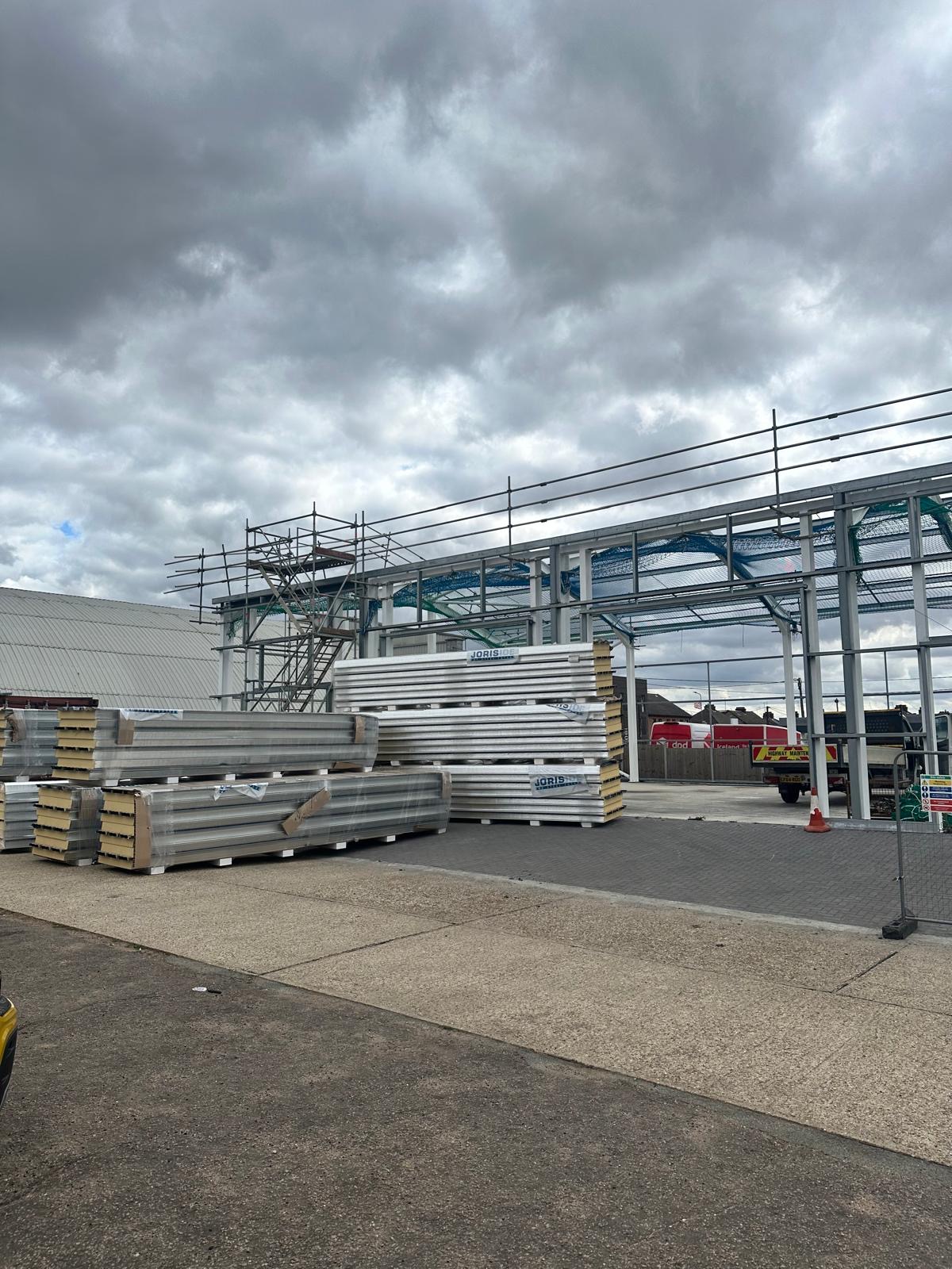 Stacks of insulated cladding panels awaiting installation at Springwood Court
