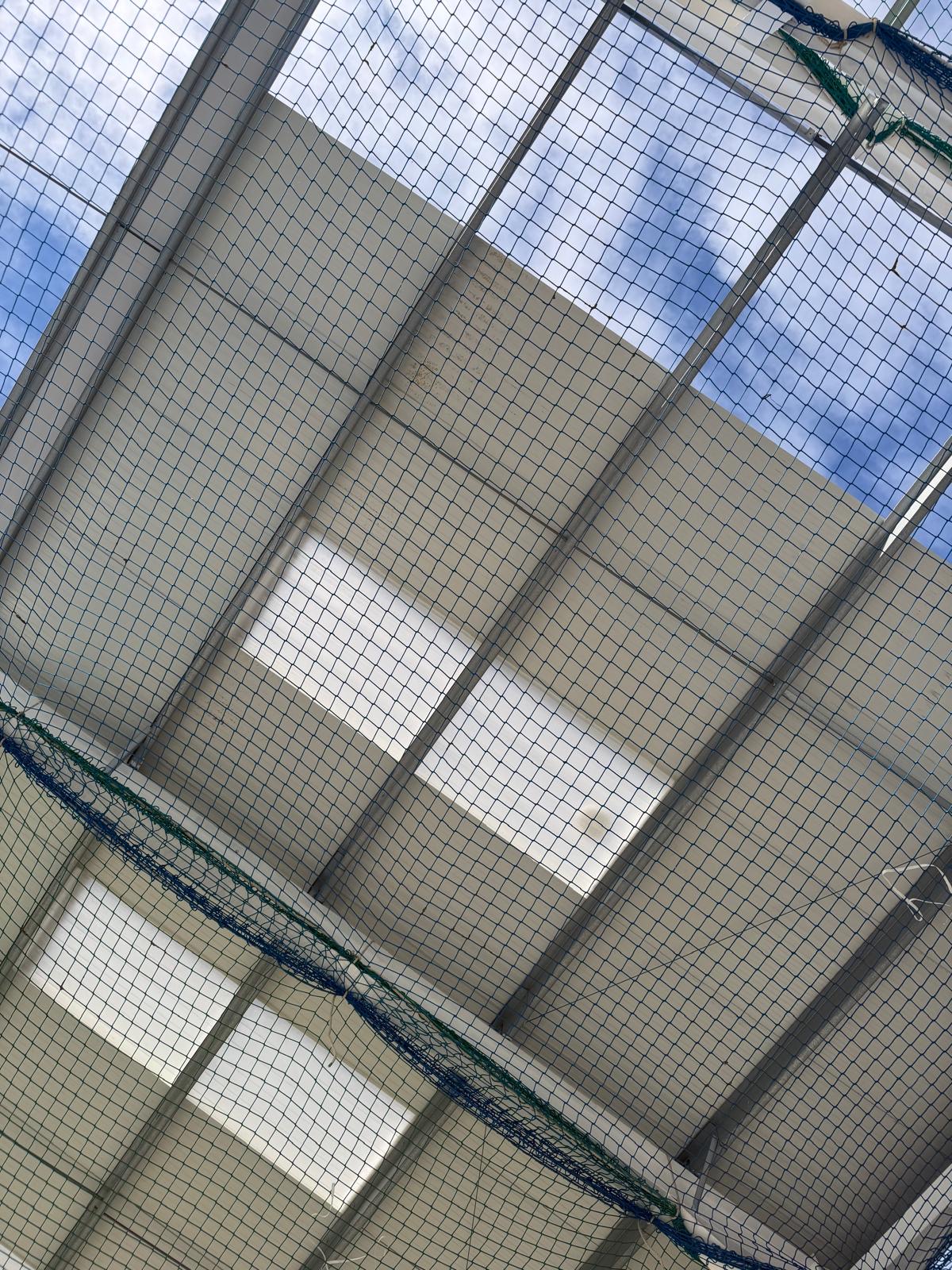 Internal liner sheets fixed under an industrial roof above safety netting