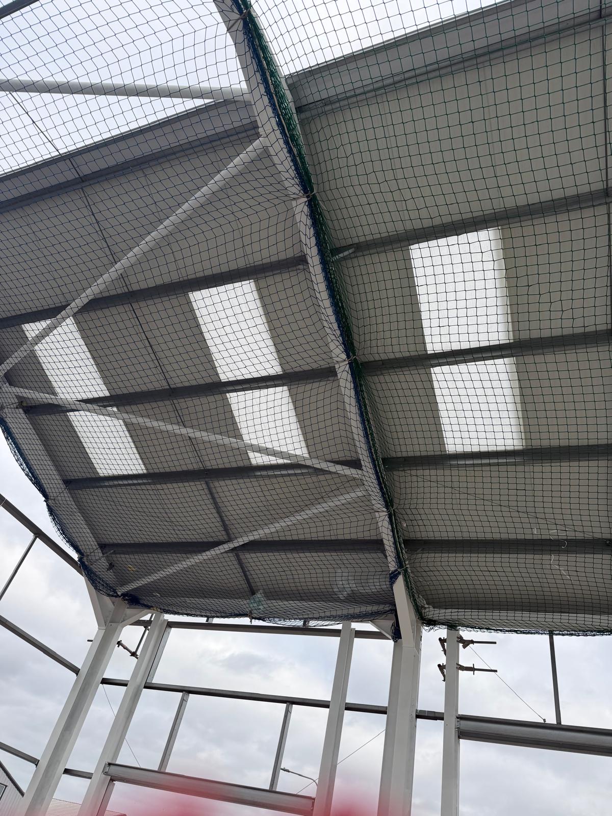 New roof liner and netting installed across a steel framed structure