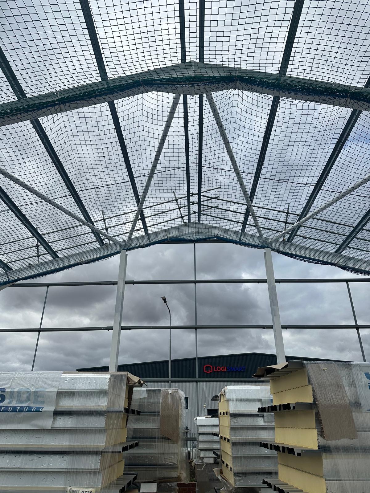 Roof safety netting across the Springwood Court portal frame during construction