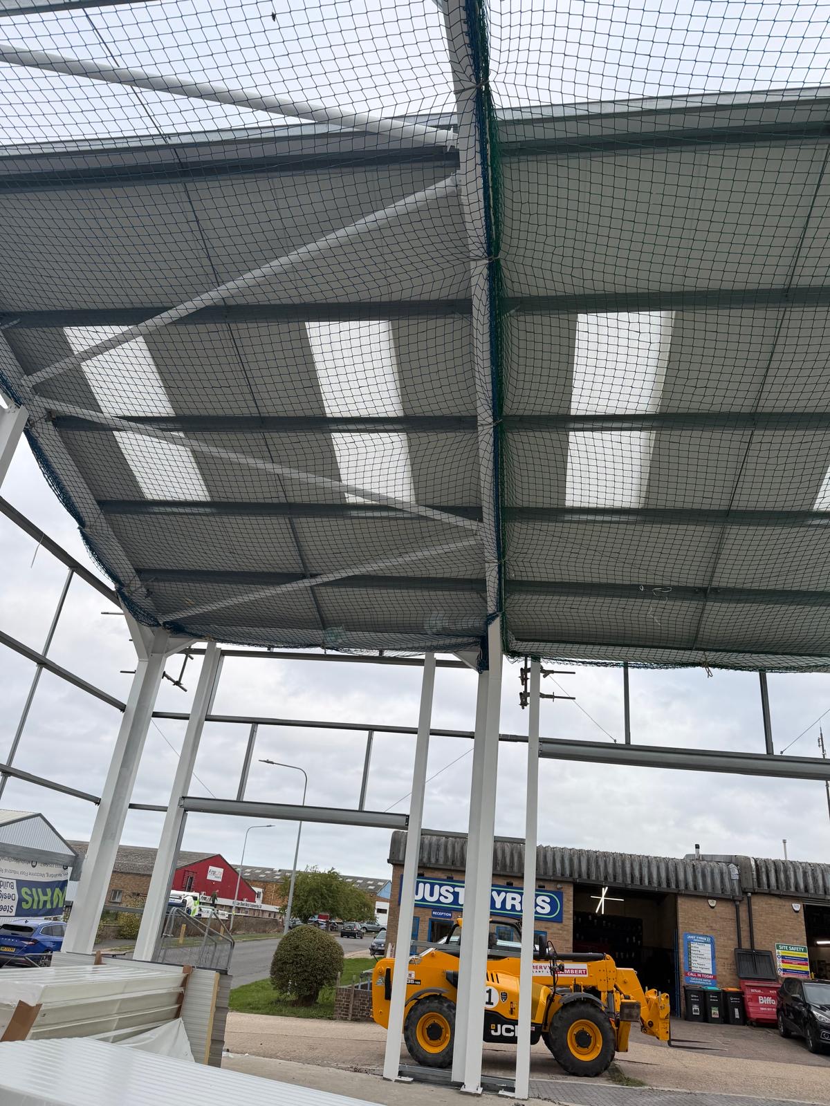 Steel framed canopy roof with liner panels viewed from below on site