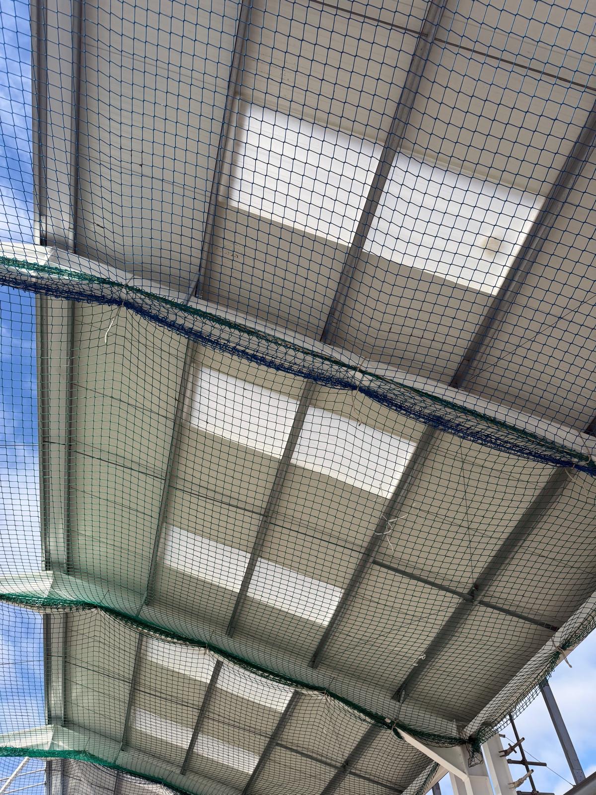 Internal roof liner panels and safety netting during an industrial roof refurbishment