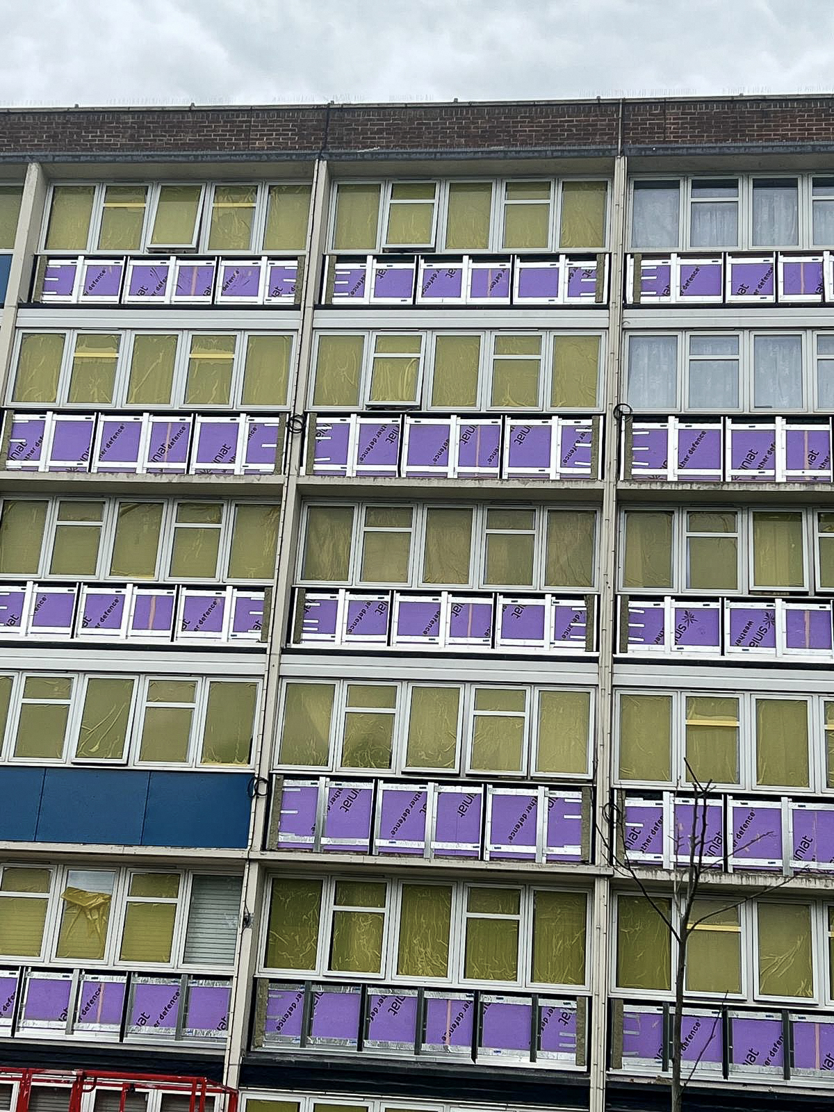 Multi-storey building with new insulation fitted around rows of windows