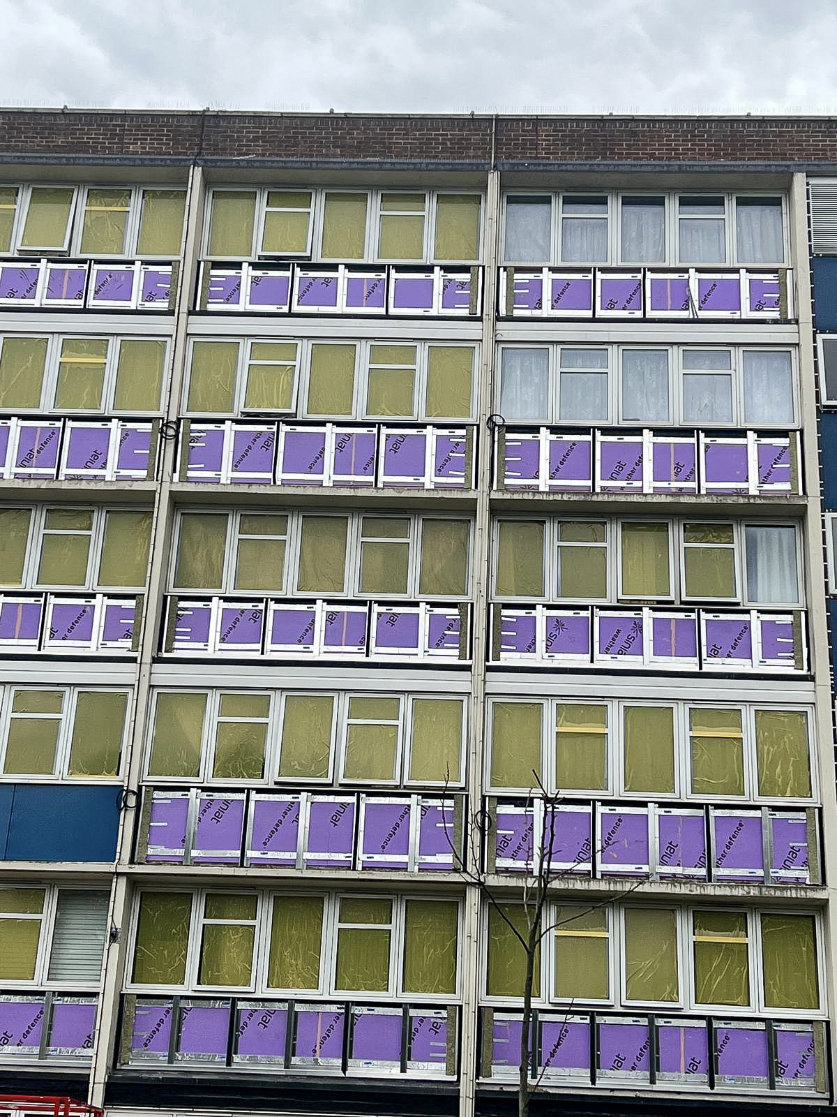 Multi-storey building facade during insulation and cladding refurbishment